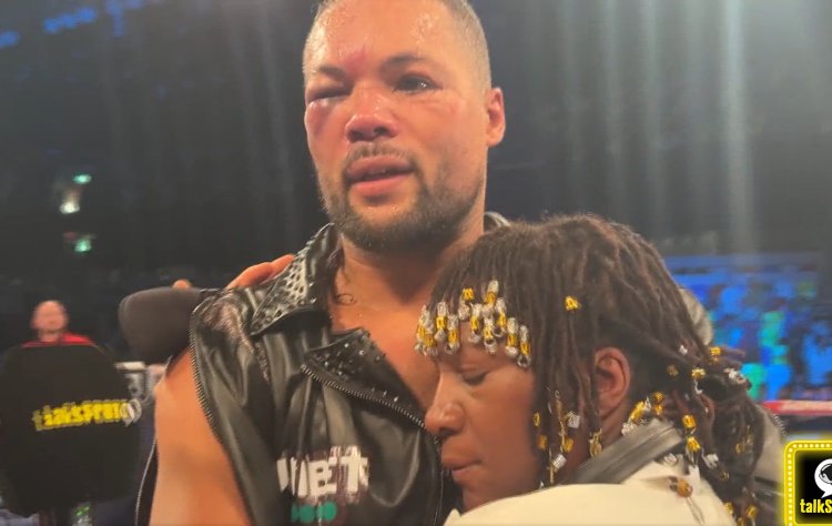 Joyce calms his Nigerian mother Melvin Opara as she interrupts post-fight interview